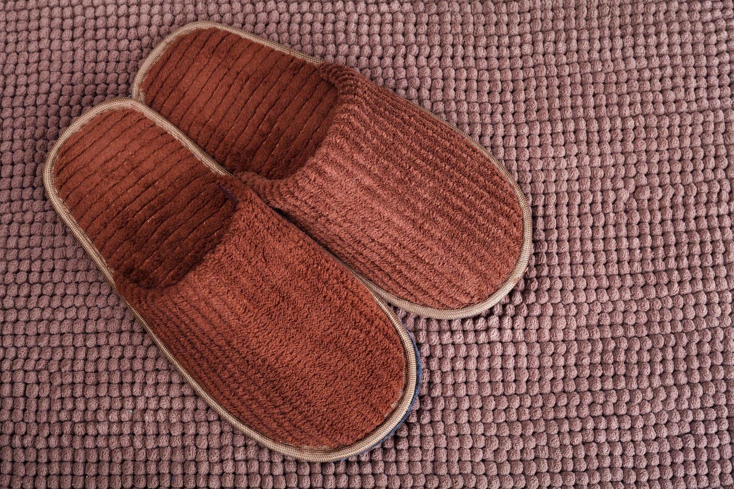 Brown wool slipper on mat photo