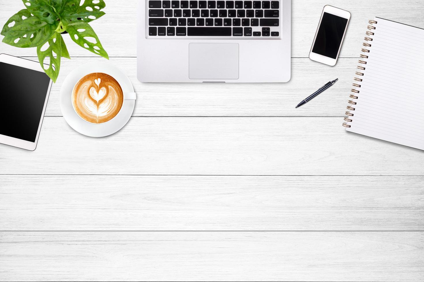 Modern workspace with laptop tablet, smartphone and coffee cup copy space on white wood table background. Top view. Flat lay style. photo