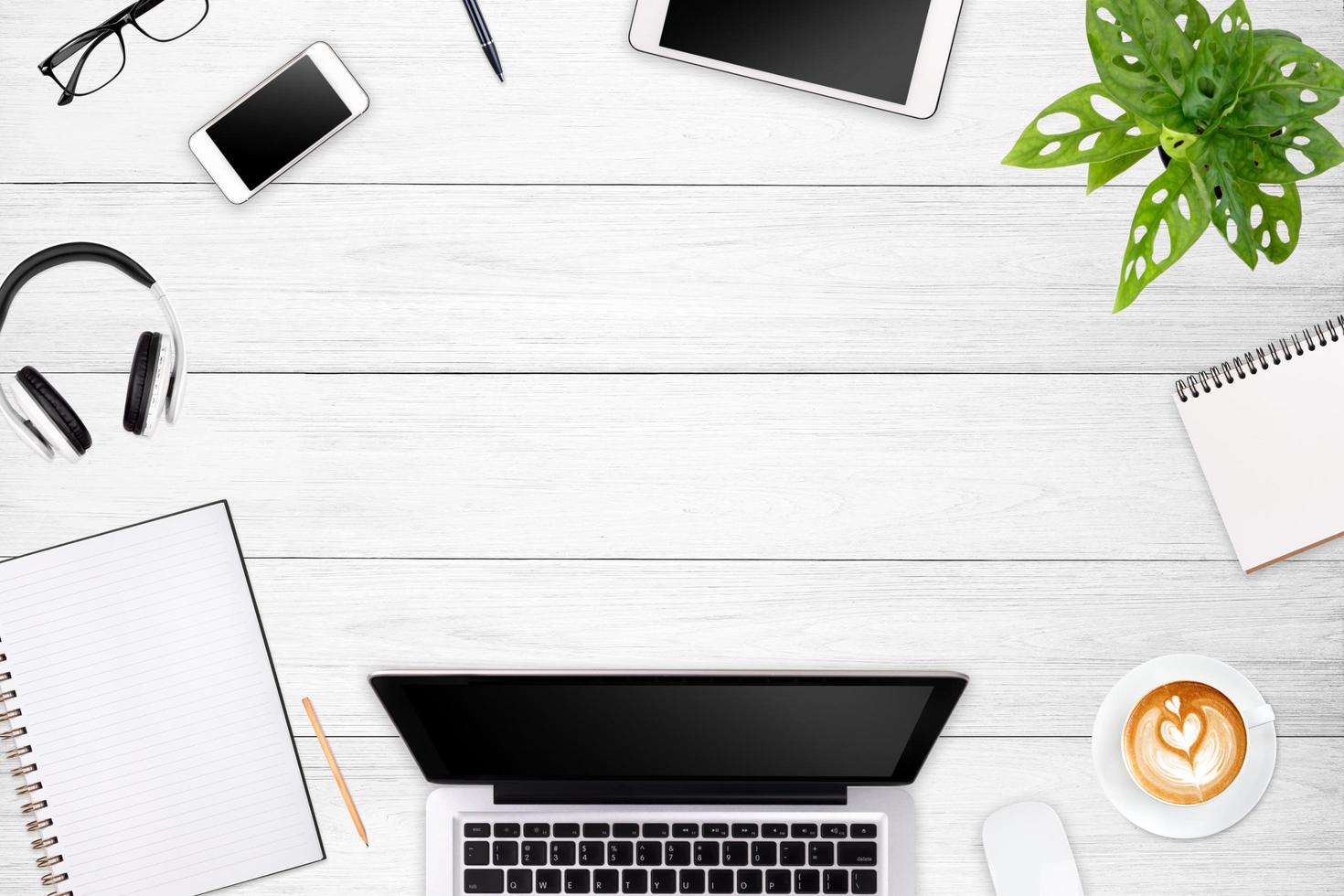 Modern workspace with laptop tablet, smartphone and coffee cup copy space on color background. Top view. Flat lay style. photo