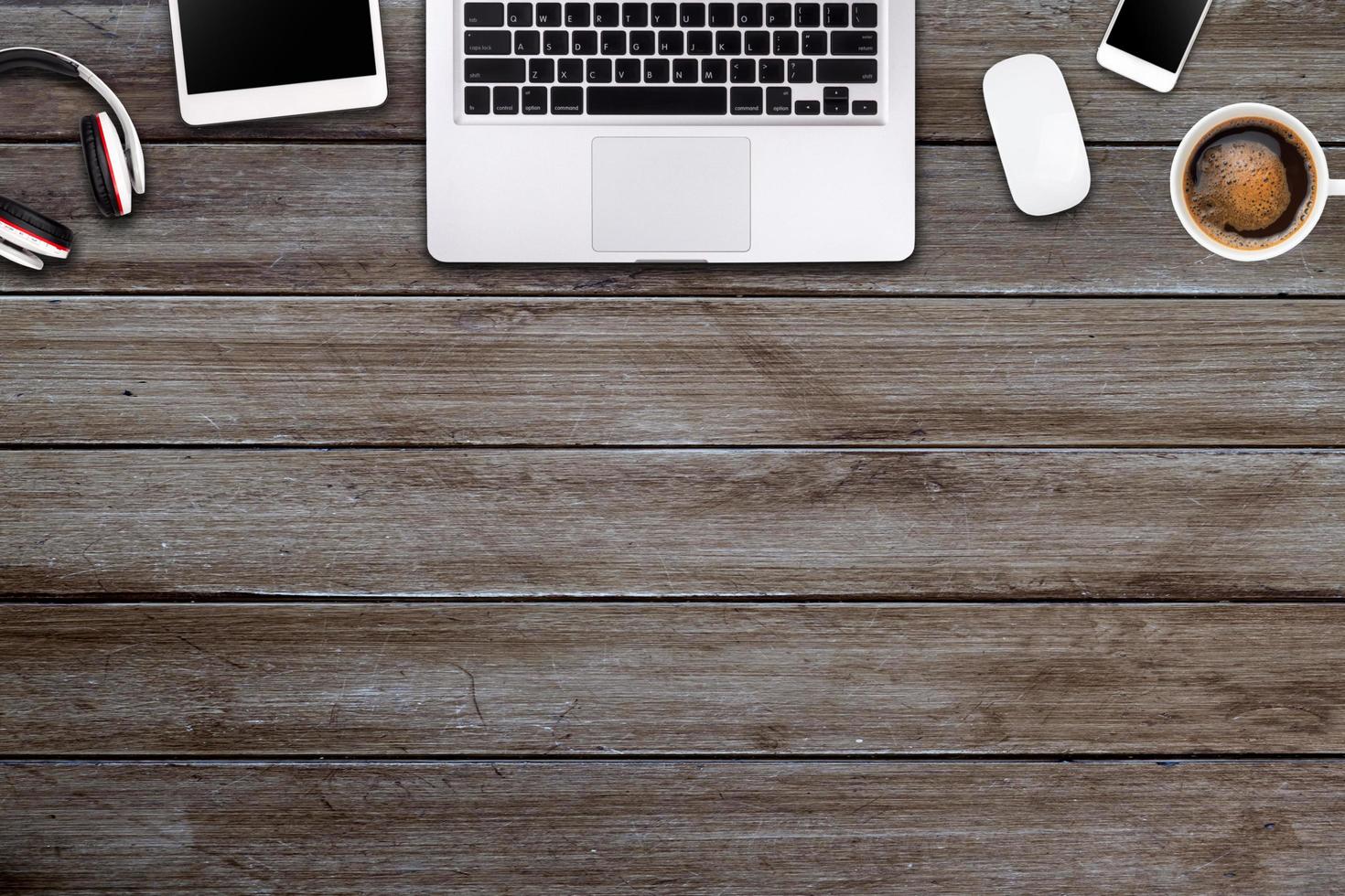 Modern workspace with laptop tablet, smartphone and coffee cup copy space on wood background. Top view. Flat lay style. photo