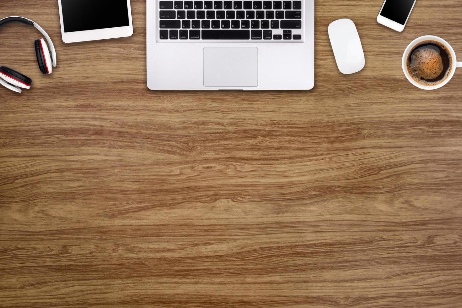 Modern workspace with laptop tablet, smartphone and coffee cup copy space on wood background. Top view. Flat lay style. photo