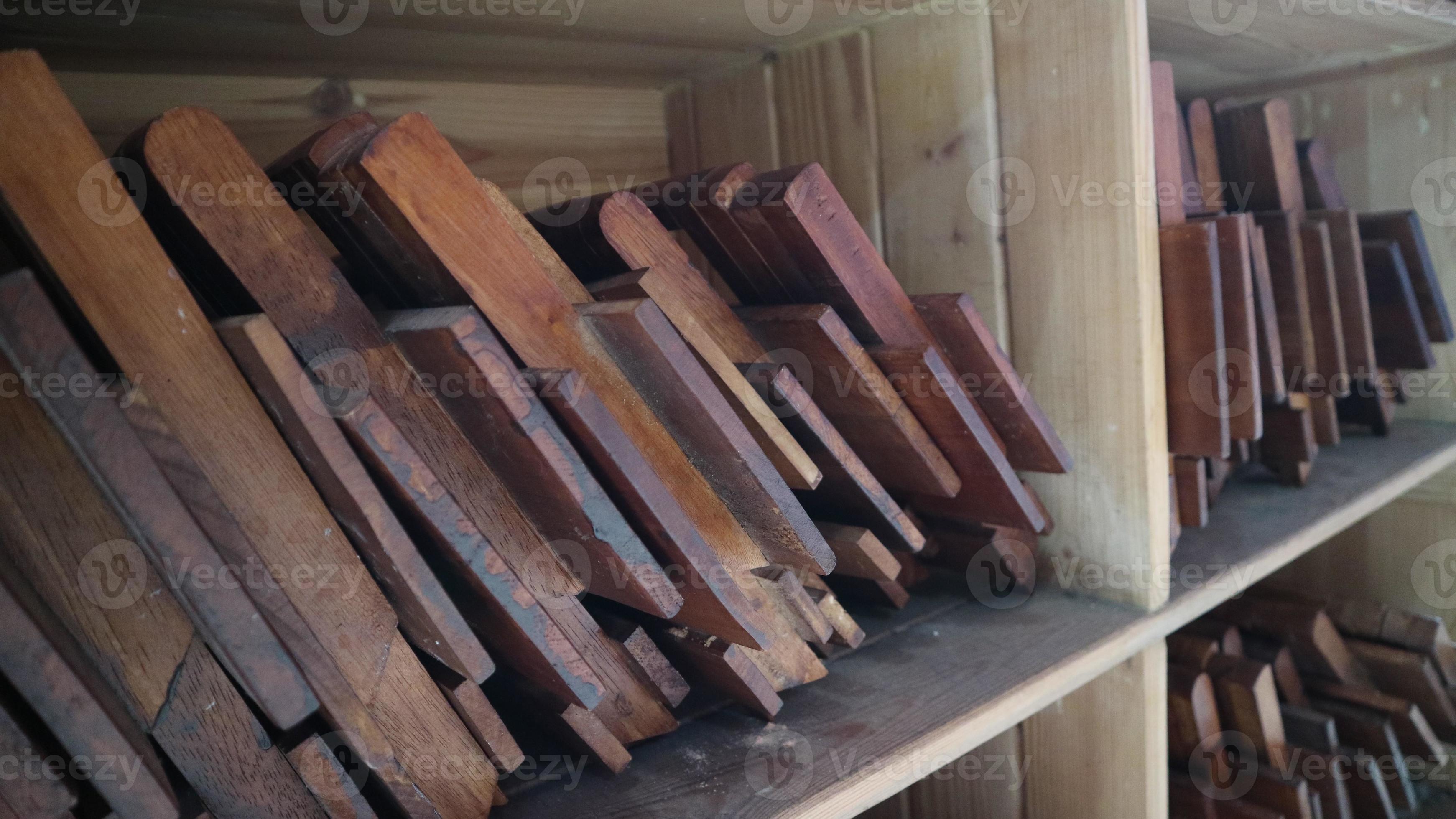 Stacks of small brown folding tables for learning the Koran 11045433