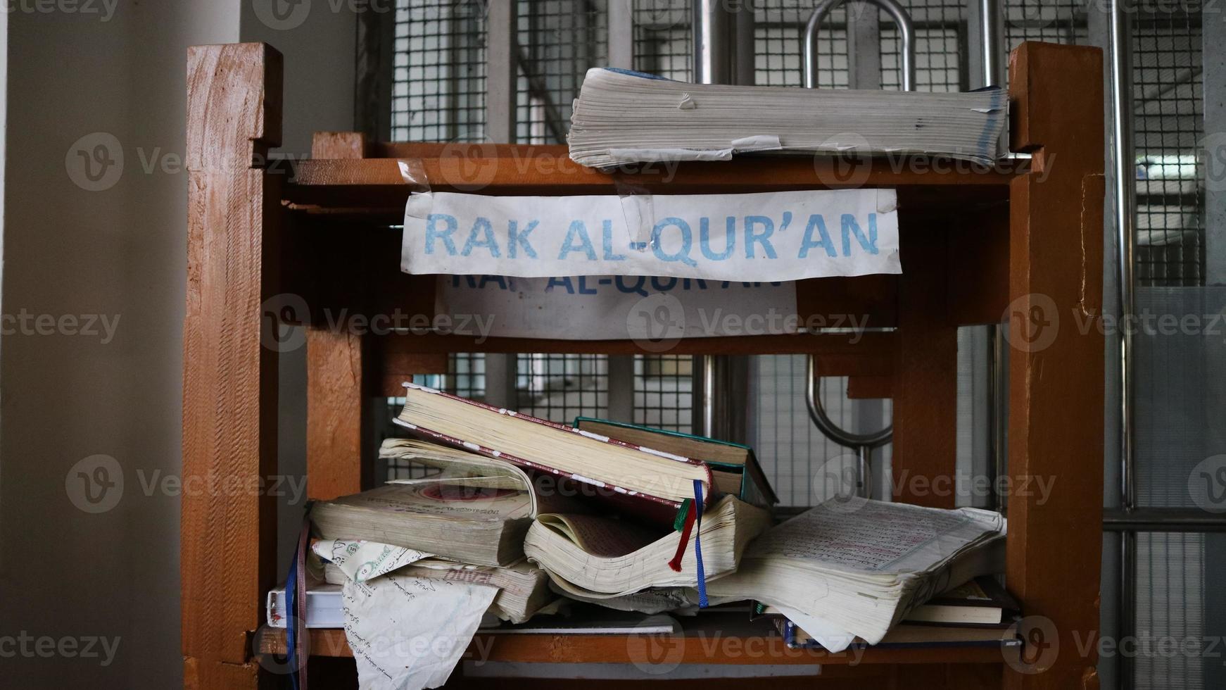 Stacks of small brown folding tables for learning the Koran photo
