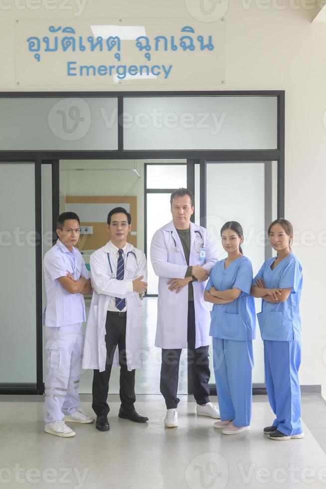 An Asian professional confidence medic team are walking  in hospital, health care concept . photo