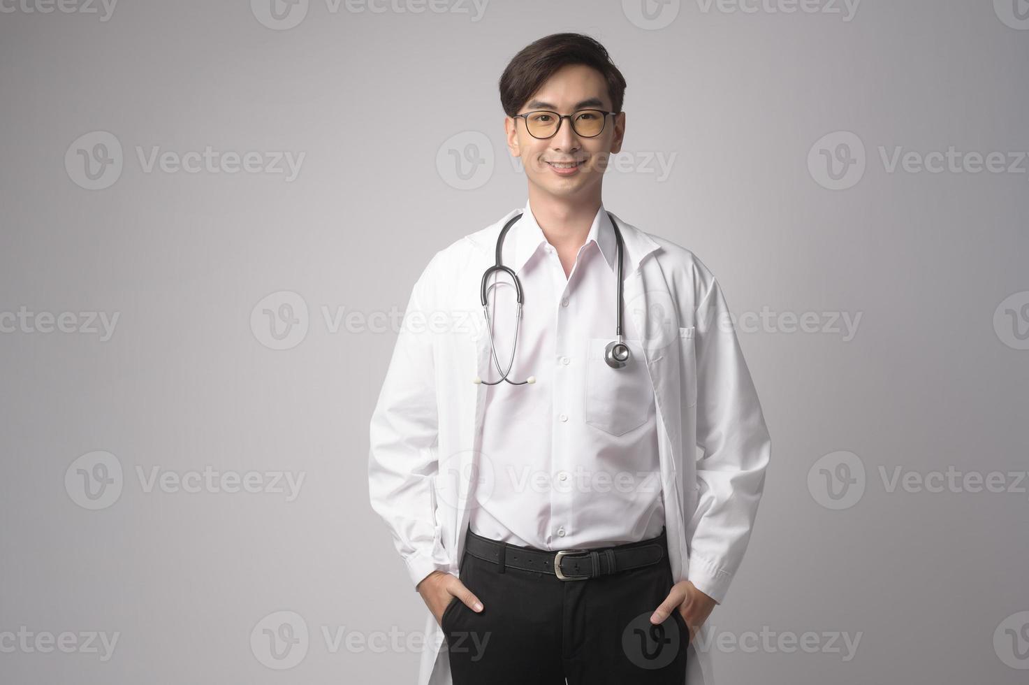 Portrait of male confident doctor over white background studio, healthcare and Medical technology concept. photo