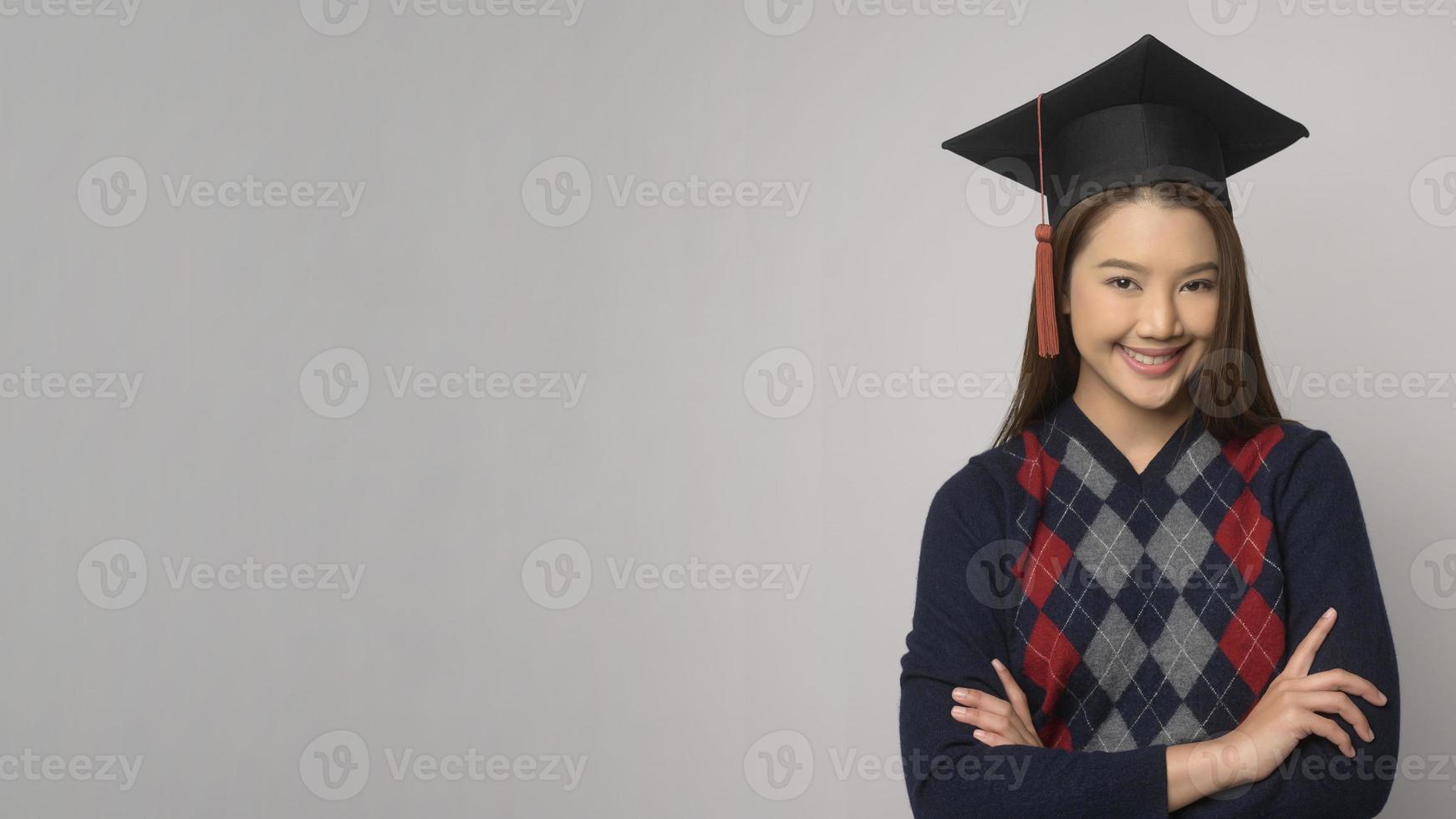 Young smiling woman holding graduation hat, education and university concept photo