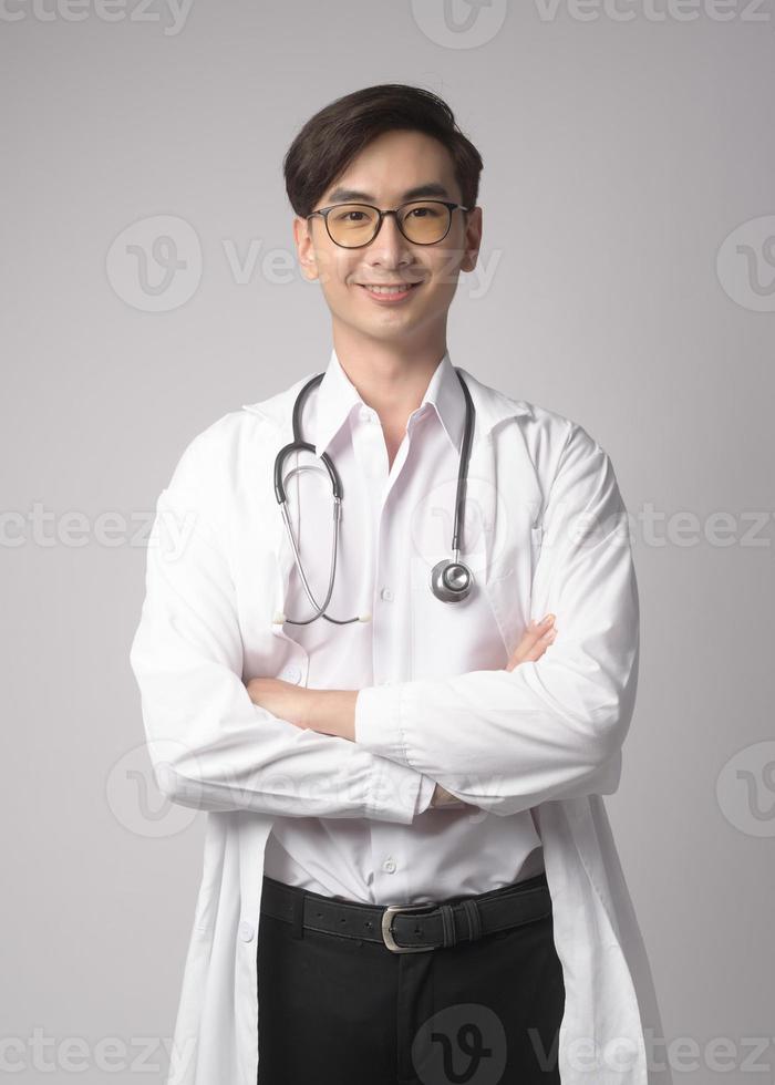 Portrait of male confident doctor over white background studio, healthcare and Medical technology concept. photo