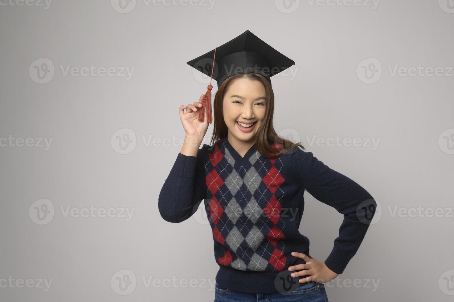 Young smiling woman holding graduation hat, education and university concept photo
