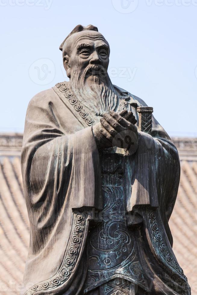 Bronze statue of Confucius in traditional pose photo