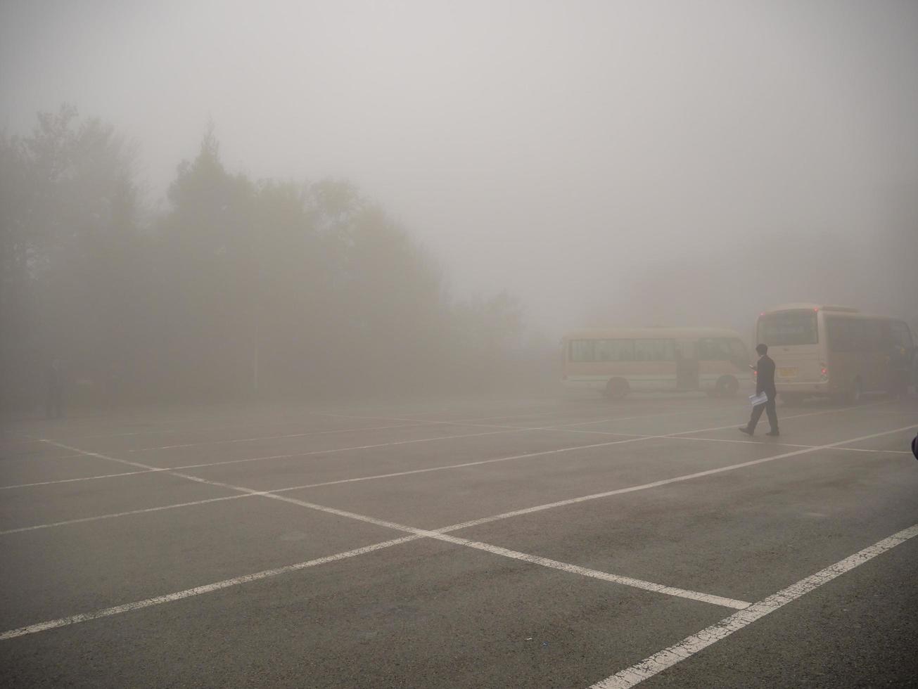 zhangjiajie China - 14 October 2018 Bus and Taxi car on the Tianzi mountain in Zhangjiajie National Forest Park in Wulingyuan District Zhangjiajie City China in the Foggy day. photo