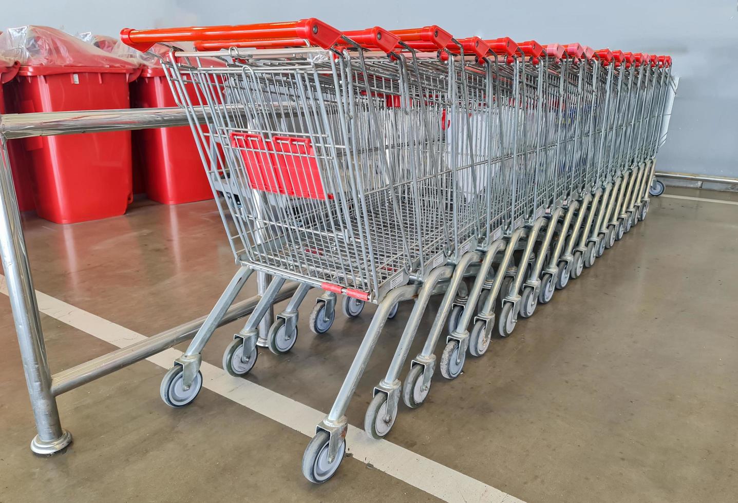 Row of shopping carts in front of entrance to supermarket. photo