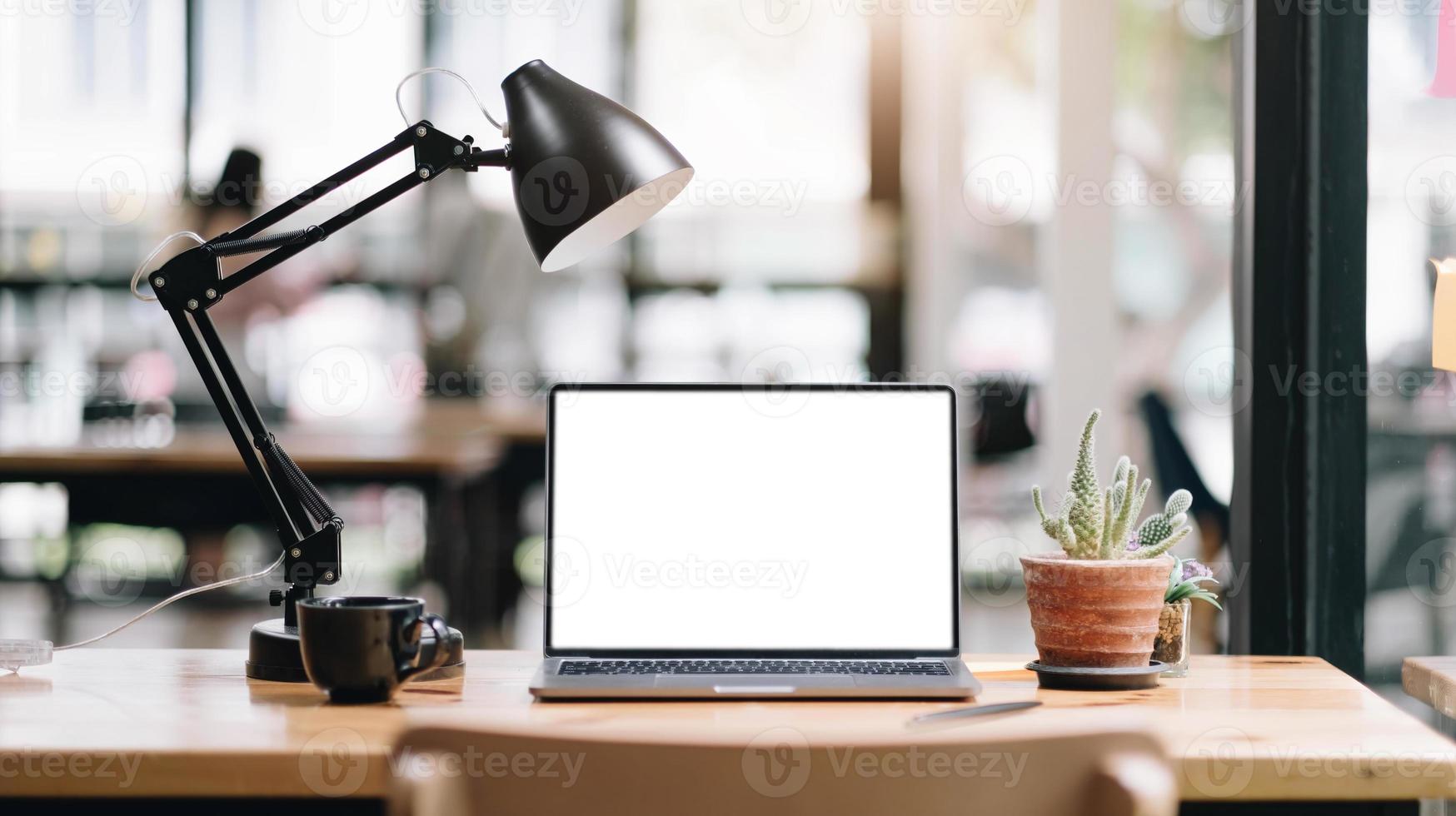 Workspace blank screen Computer and equipment on table and blurred background photo
