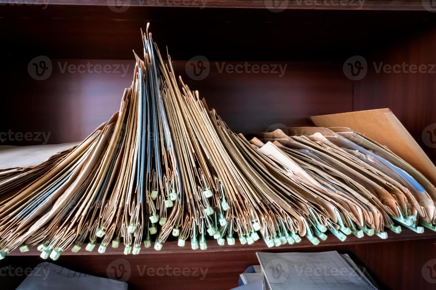 Old folders with documents in the library. photo