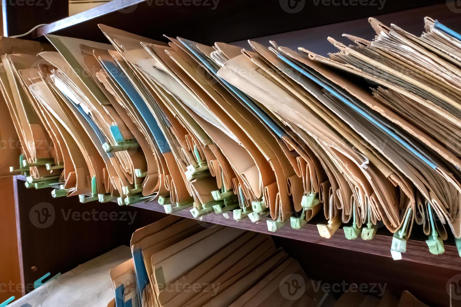 Old folders with documents in the library. photo