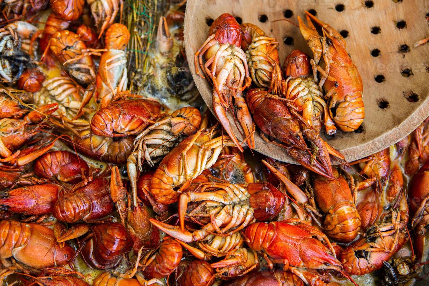 Boiled red crayfish or crawfish with herbs. Crayfish boiling in the pot on the fire photo