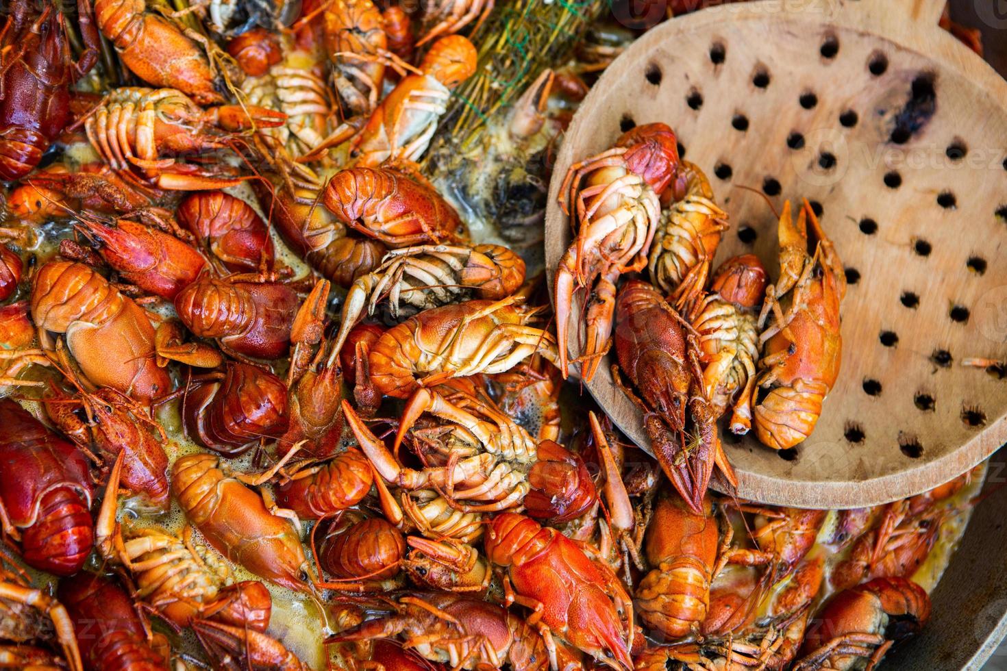 Boiled red crayfish or crawfish with herbs. Crayfish boiling in the pot on the fire photo