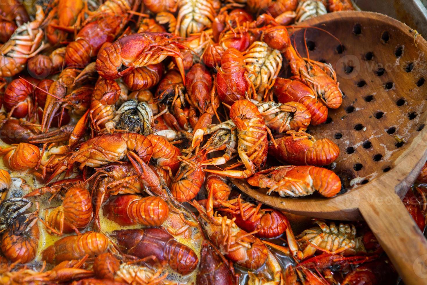 Boiled red crayfish or crawfish with herbs. Crayfish boiling in the pot on the fire photo