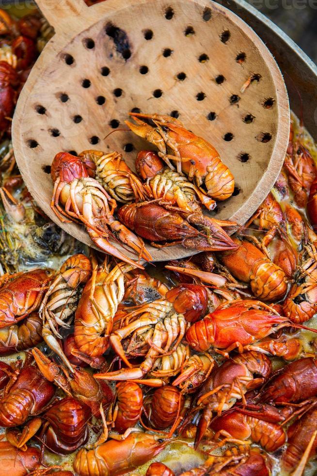 Boiled red crayfish or crawfish with herbs. Crayfish boiling in the pot on the fire photo