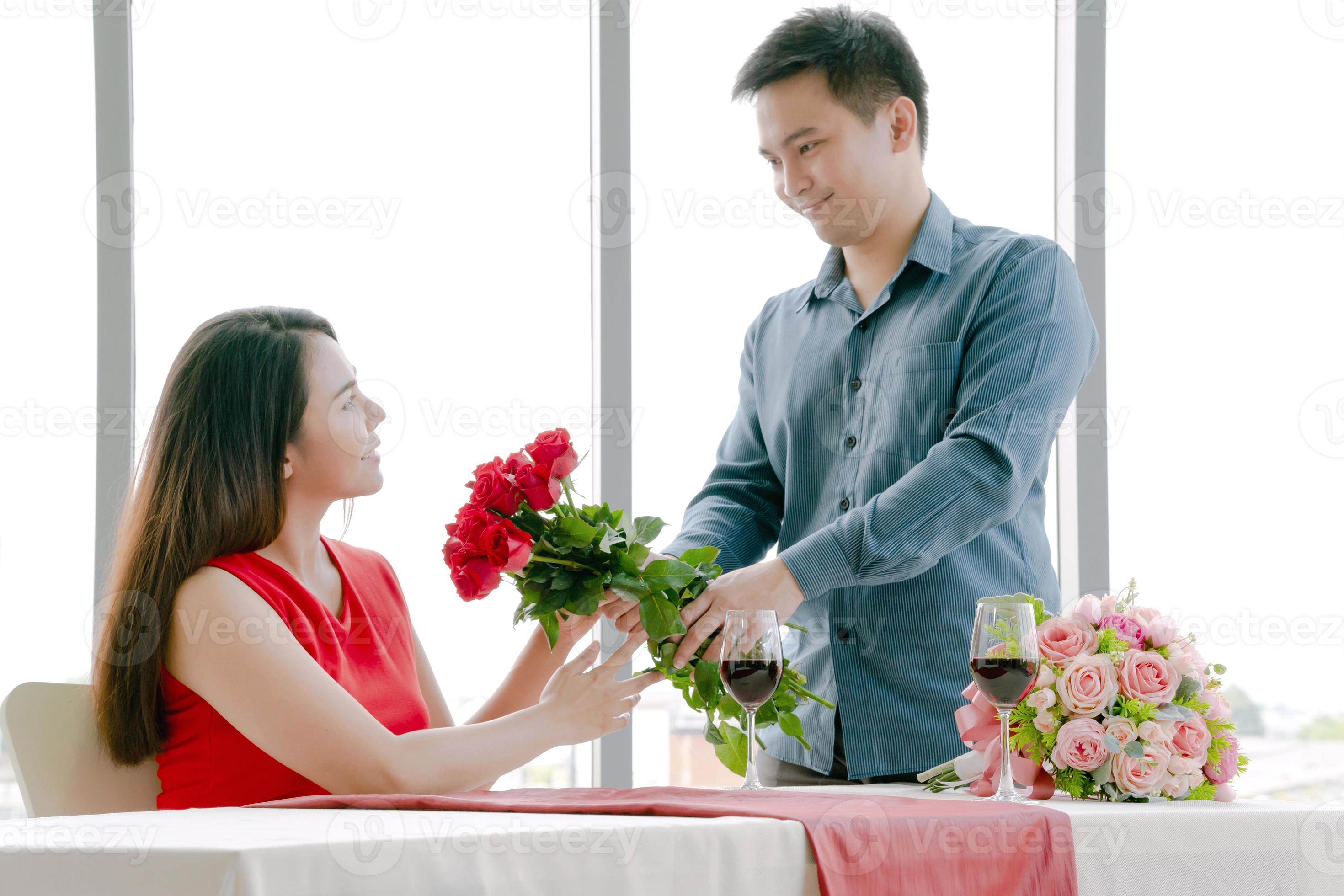 Man giving red rose bouquet with woman 11048002 Stock Photo at Vecteezy