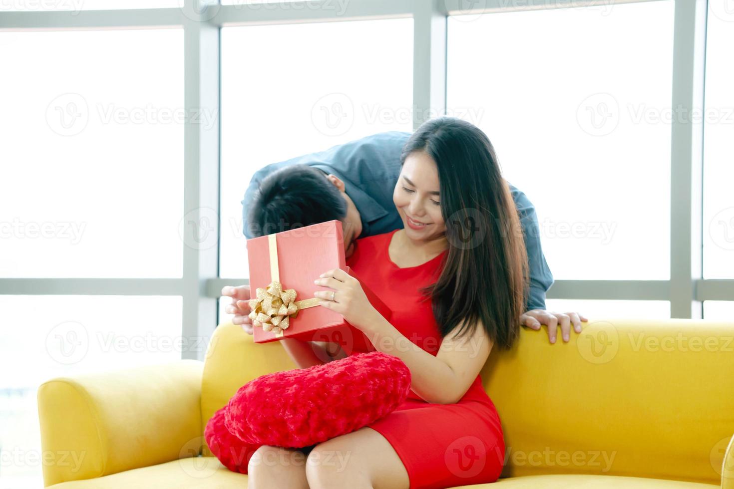 Happy married couple man and woman give a gift for holiday photo