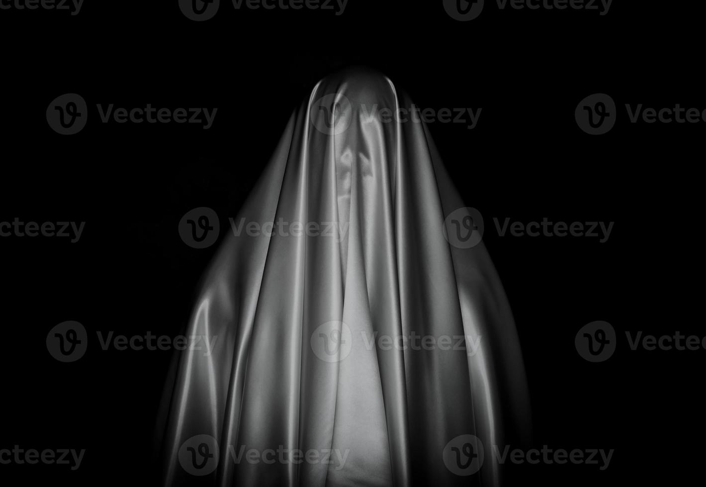 Scary white ghost sheet on black background for Halloween Festival concept. photo