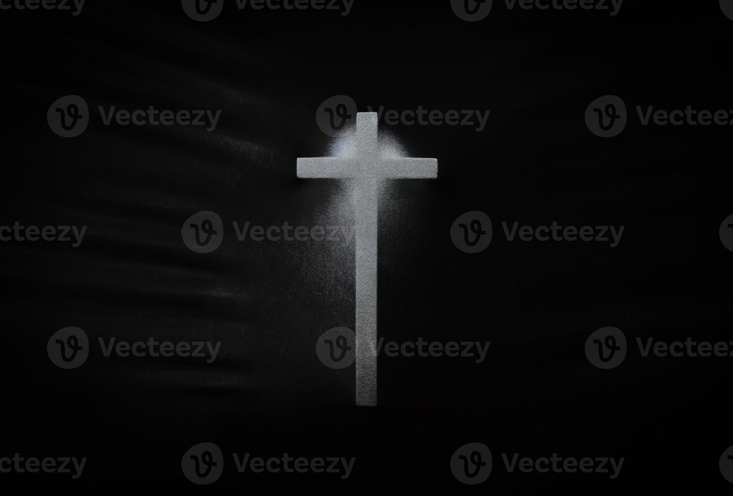 The cross pressing through black fabric with shine and dark side for Halloween background concept. photo