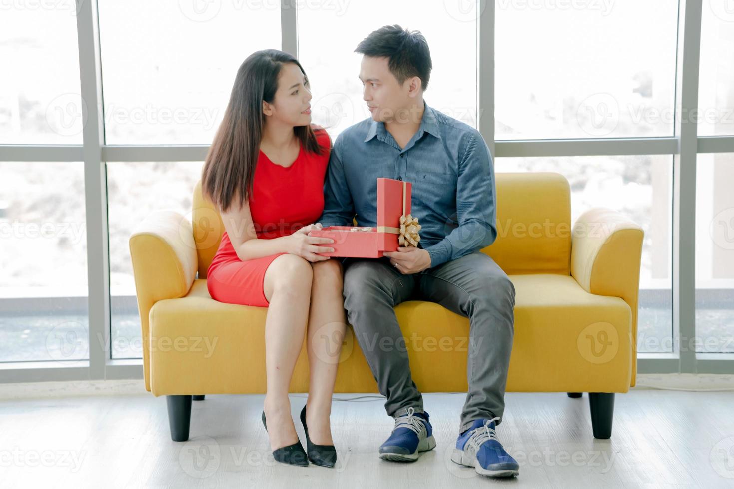 A wonderful gift. Surprised young woman is opening box and smiling. photo