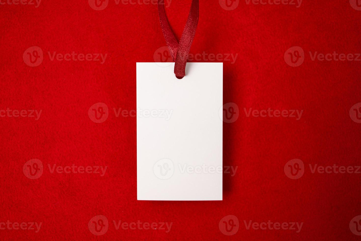 Modern advertising for cloth design. Clothes tag mock up white on red fabric. Modern design. Red fabric pattern background. Price tag. photo