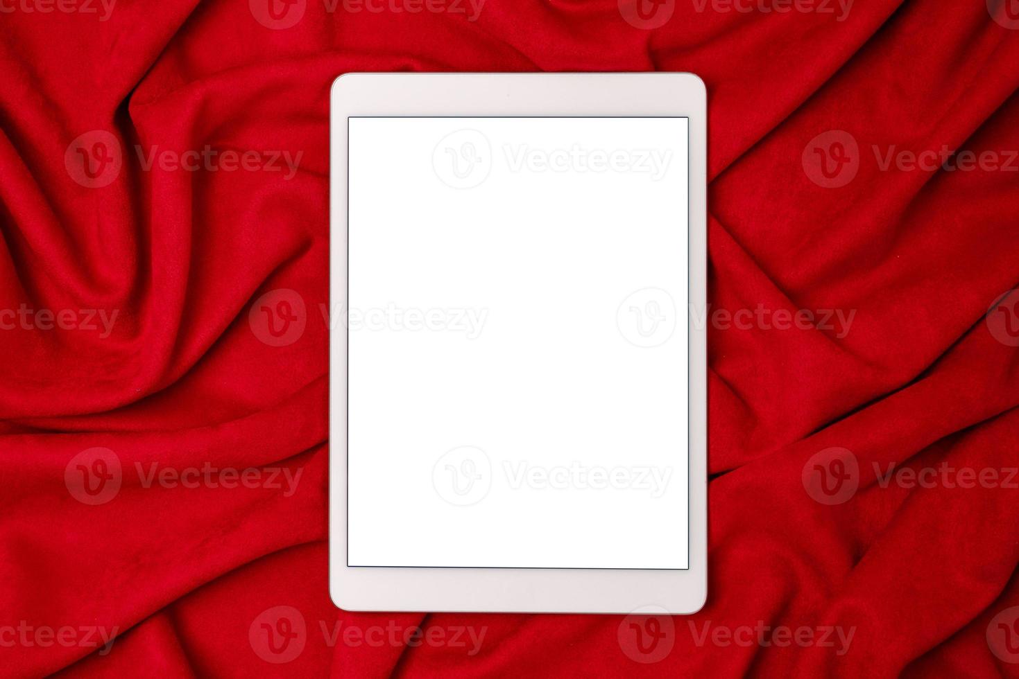 Black mock up electronic tablet on red fabric background. Mobile app mockup. Smartphone blank screen, phone mockup. photo