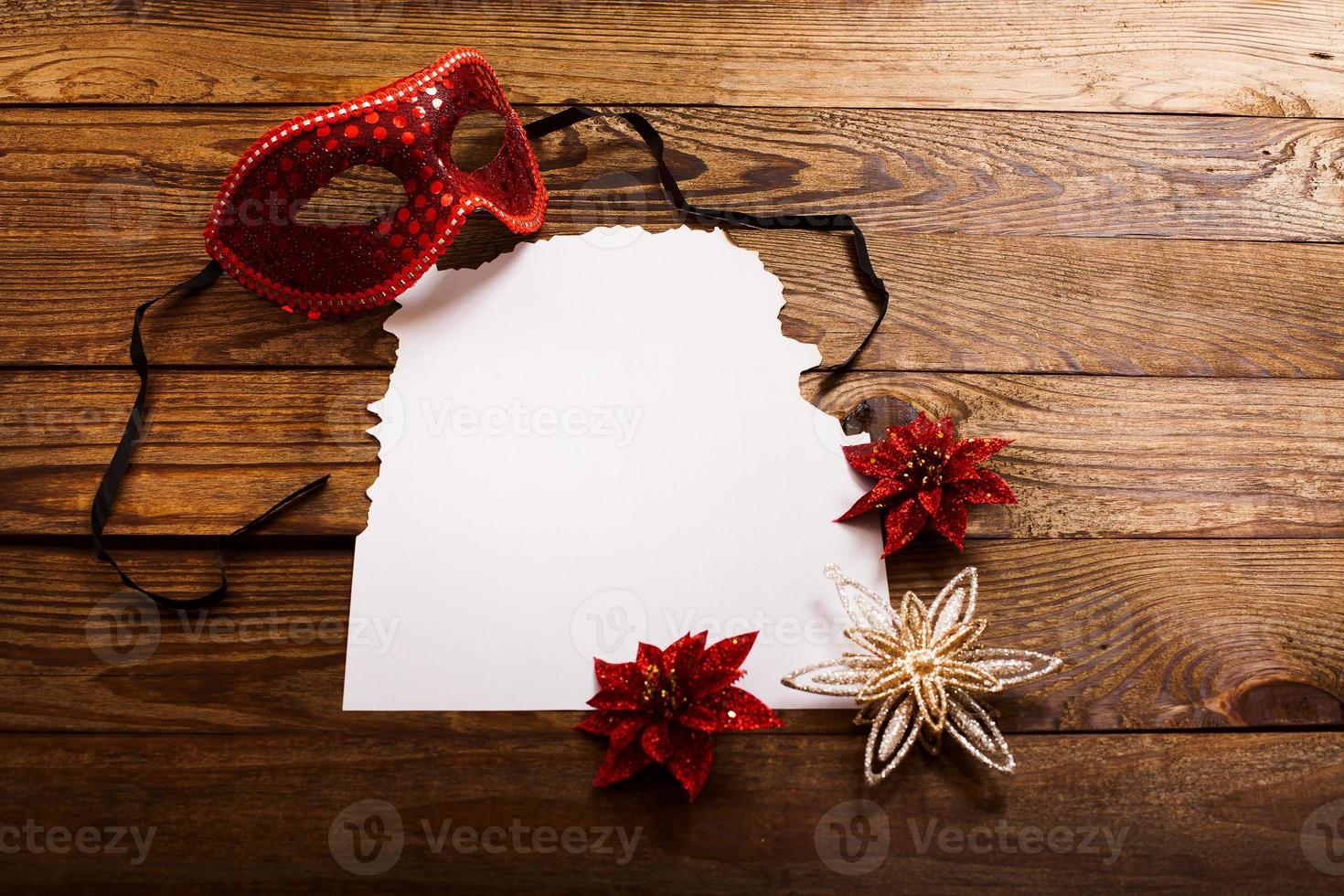 Christmas card and New Year accessories on brown wooden table. Top view. Copy space and place for text. photo