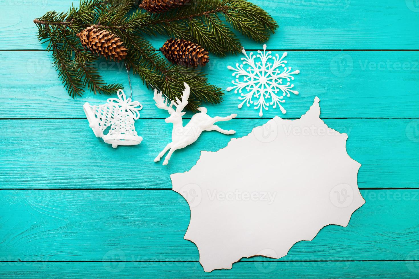 Frame of pine cones on a Christmas tree on blue wooden background. Top view photo