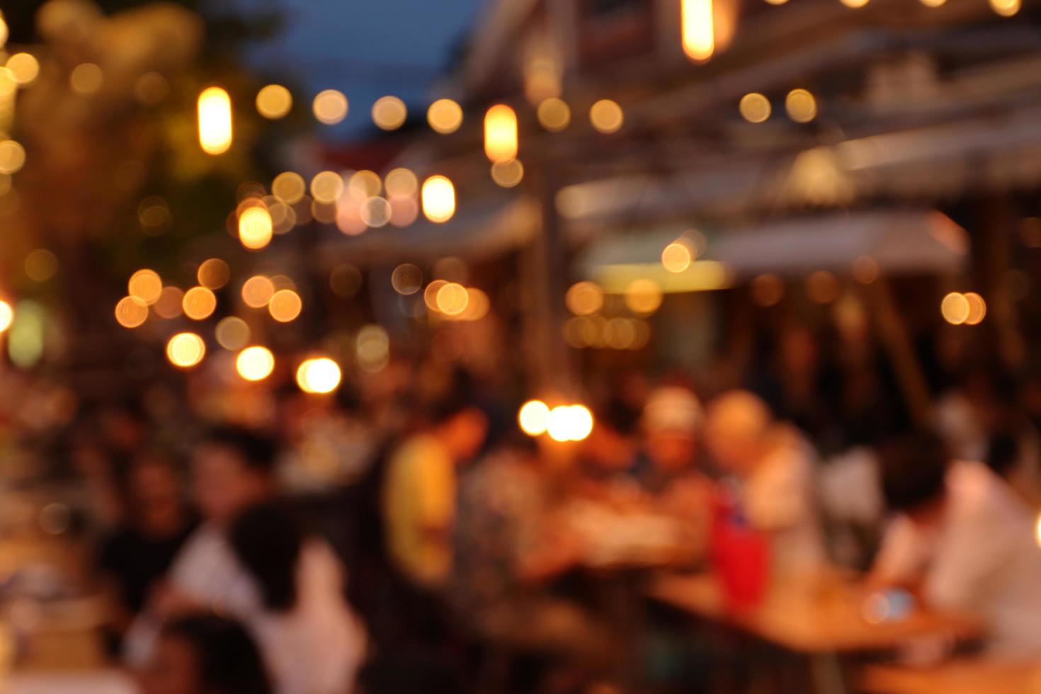 blurred image at the restaurant night time, many people in the restaurant eat and party happy relaxing photo