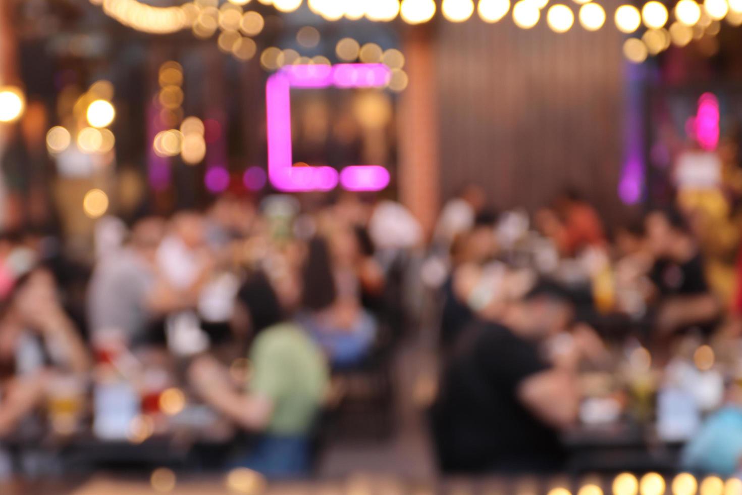 blurred image at the restaurant night time, many people in the restaurant eat and party happy relaxing photo