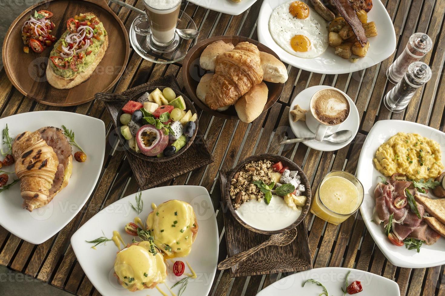 many mixed western breakfast food items on cafe table photo