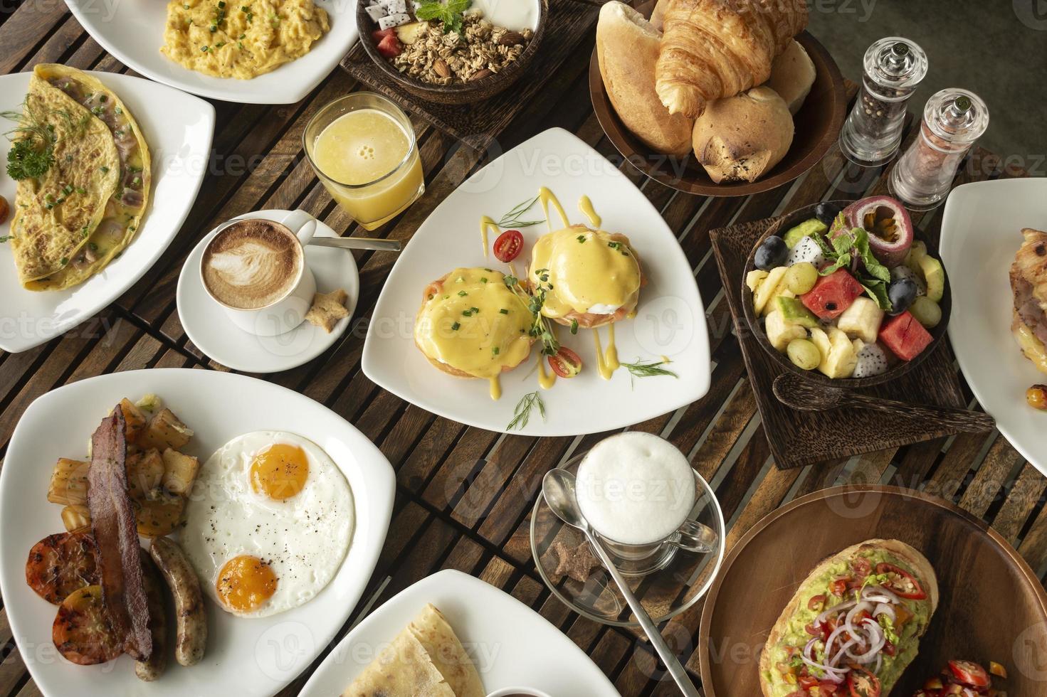 many mixed western breakfast food items on cafe table photo
