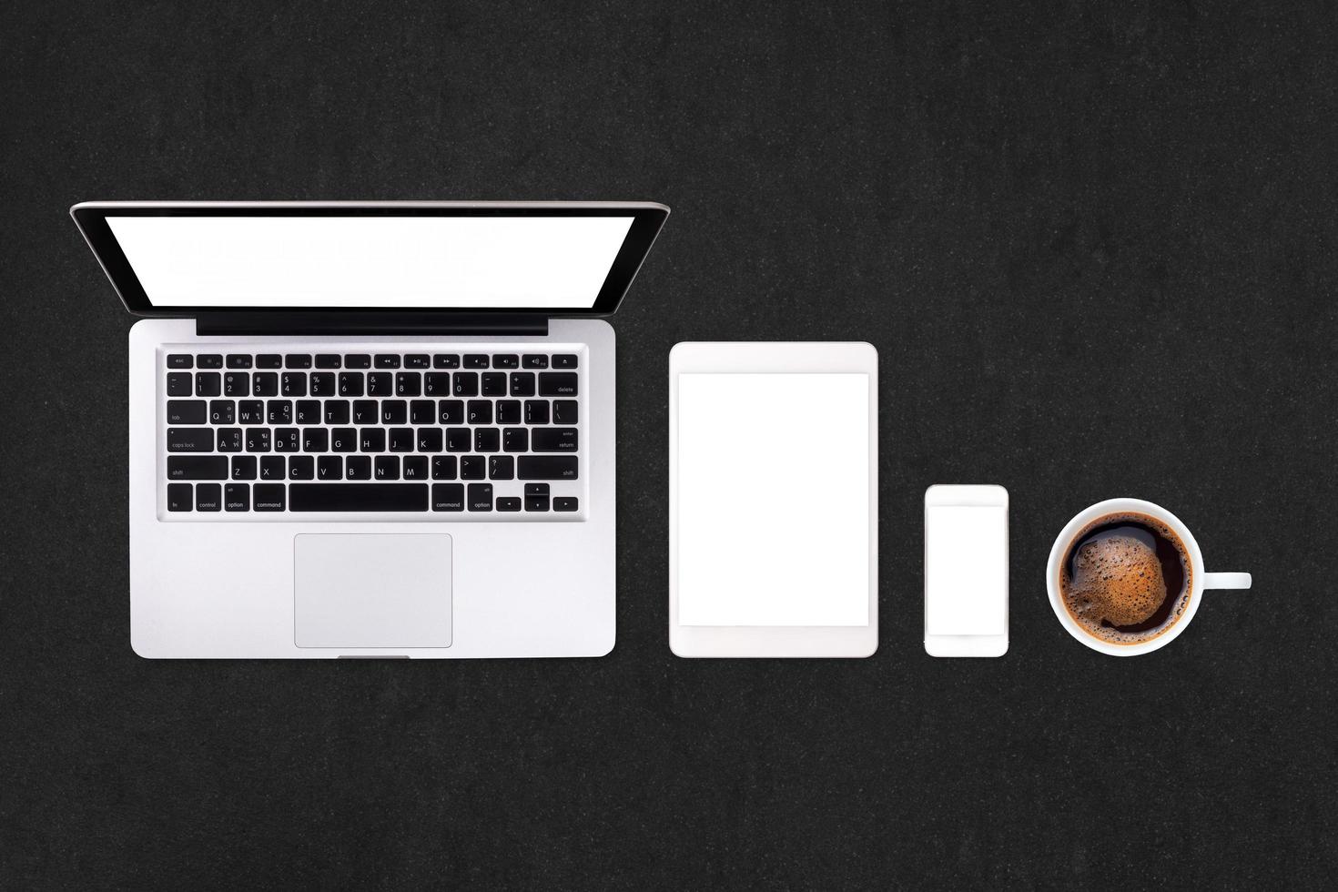 Laptop tablet smartphone  and coffee on rock table background with text space and copy space photo