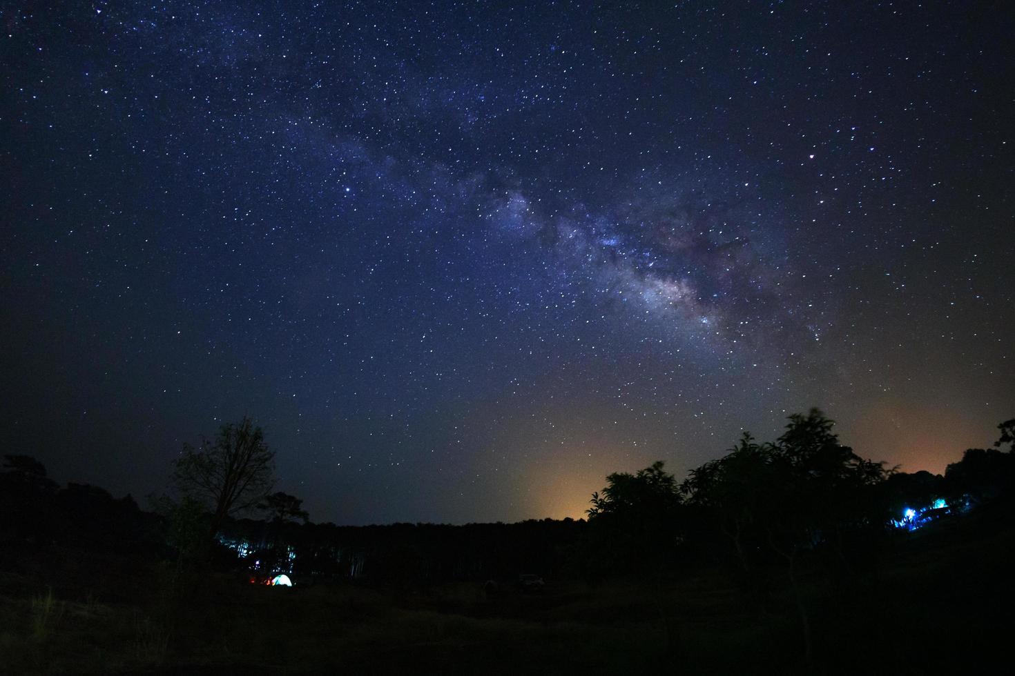 milky way galaxy and silhouette of tree with cloud at Phu Hin Rong Kla National Park,Phitsanulok Thailand photo