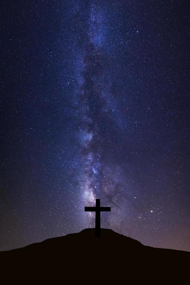 Silhouette of cross and milky way galaxy, Night sky with stars and space dust in universe photo