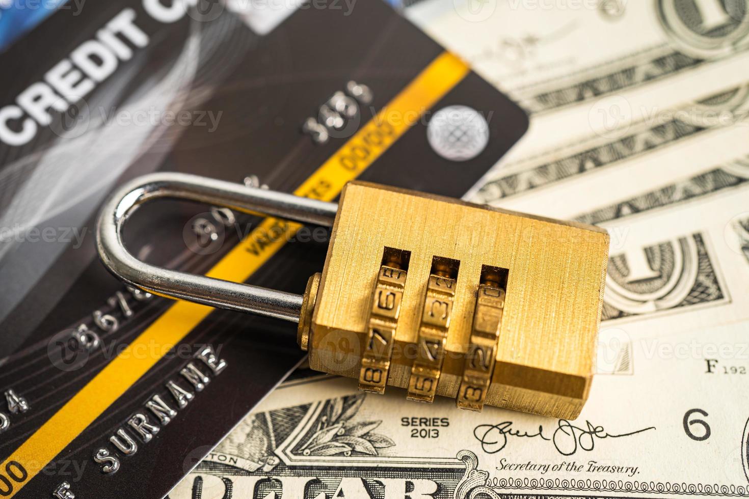 Credit card with password key lock security on US dollar background. photo