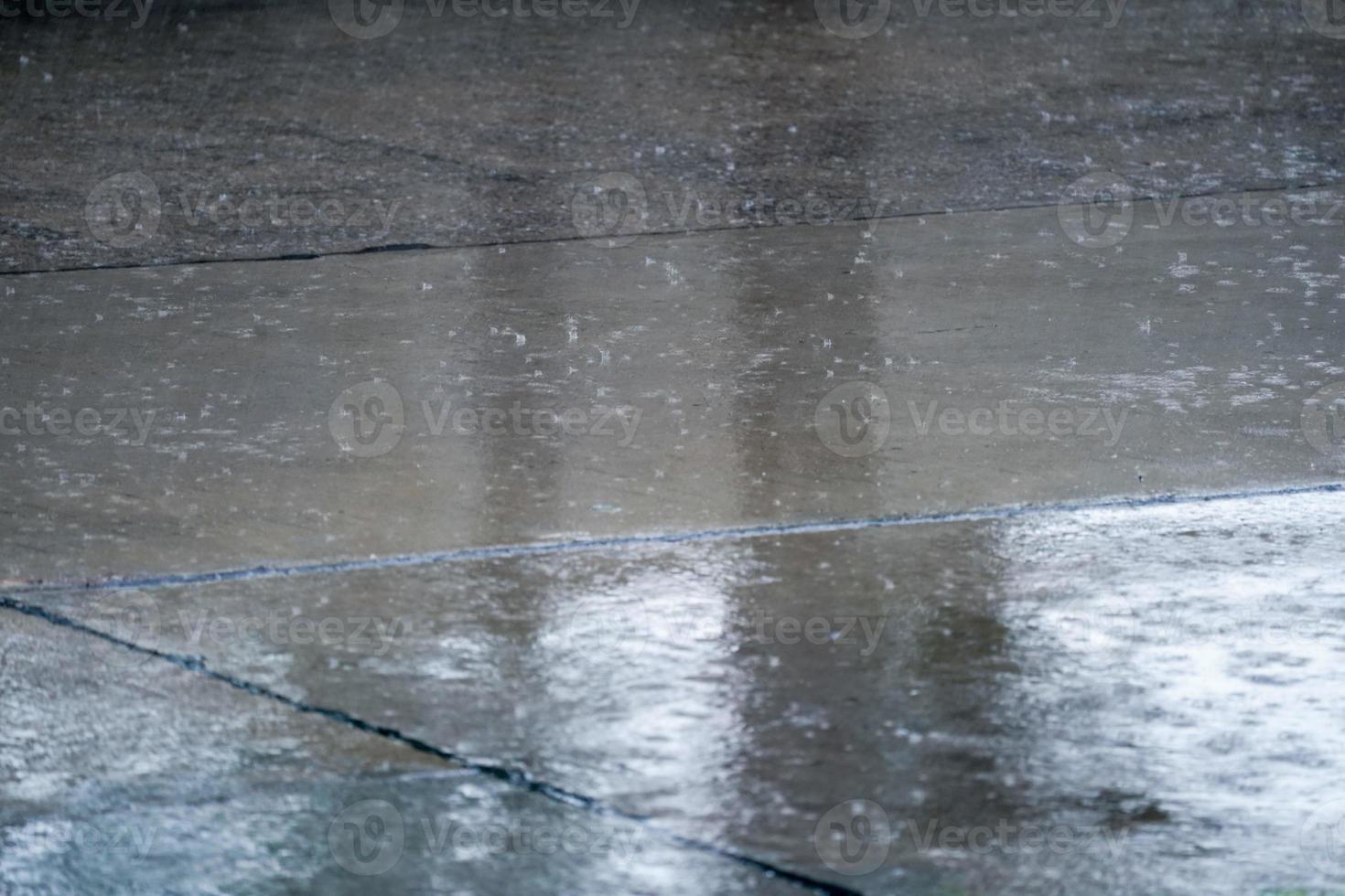 Close up the rain falling and splash on the floor. photo