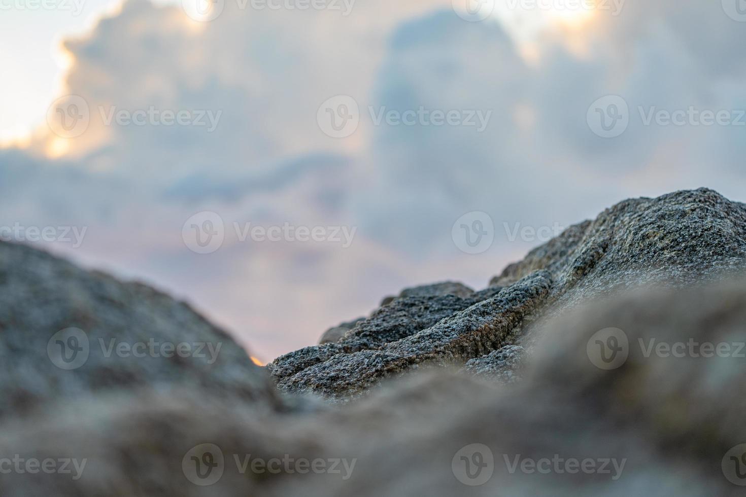 Close up to of Rock blur foreground with the cloudy sky. photo