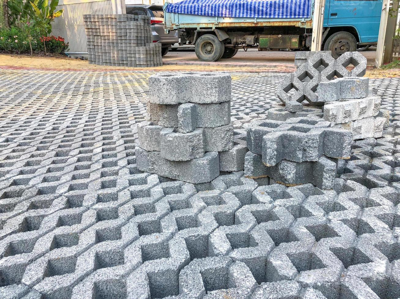 gray color stone brick block floor tile with green grass and sand as background or texture. photo