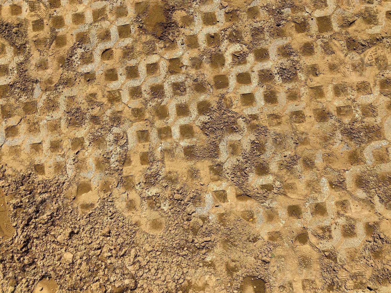 gray color stone brick block floor tile with green grass and sand as background or texture. photo