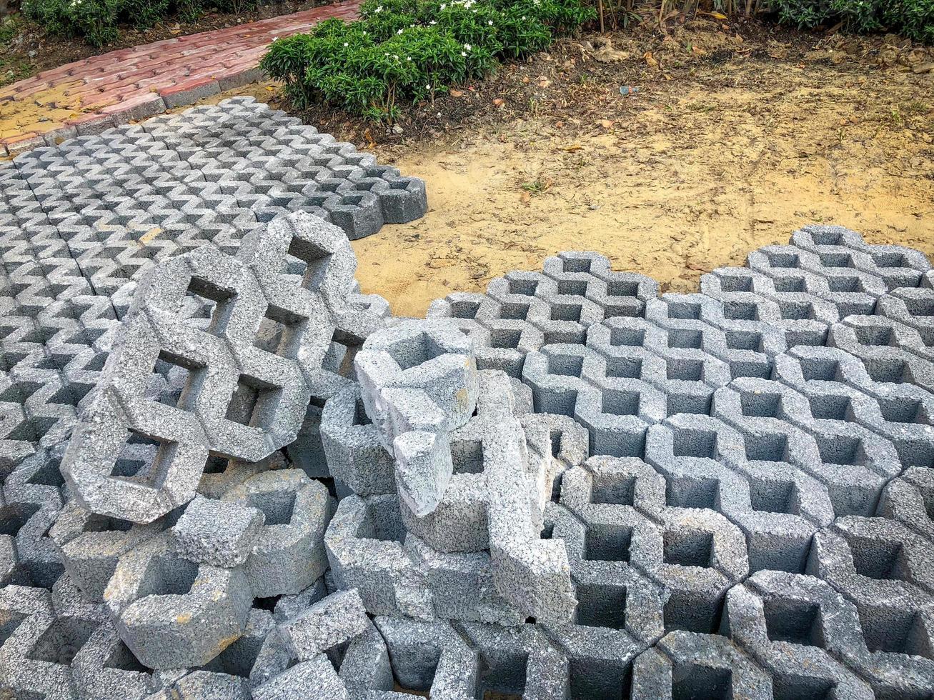 gray color stone brick block floor tile with green grass and sand as background or texture. photo