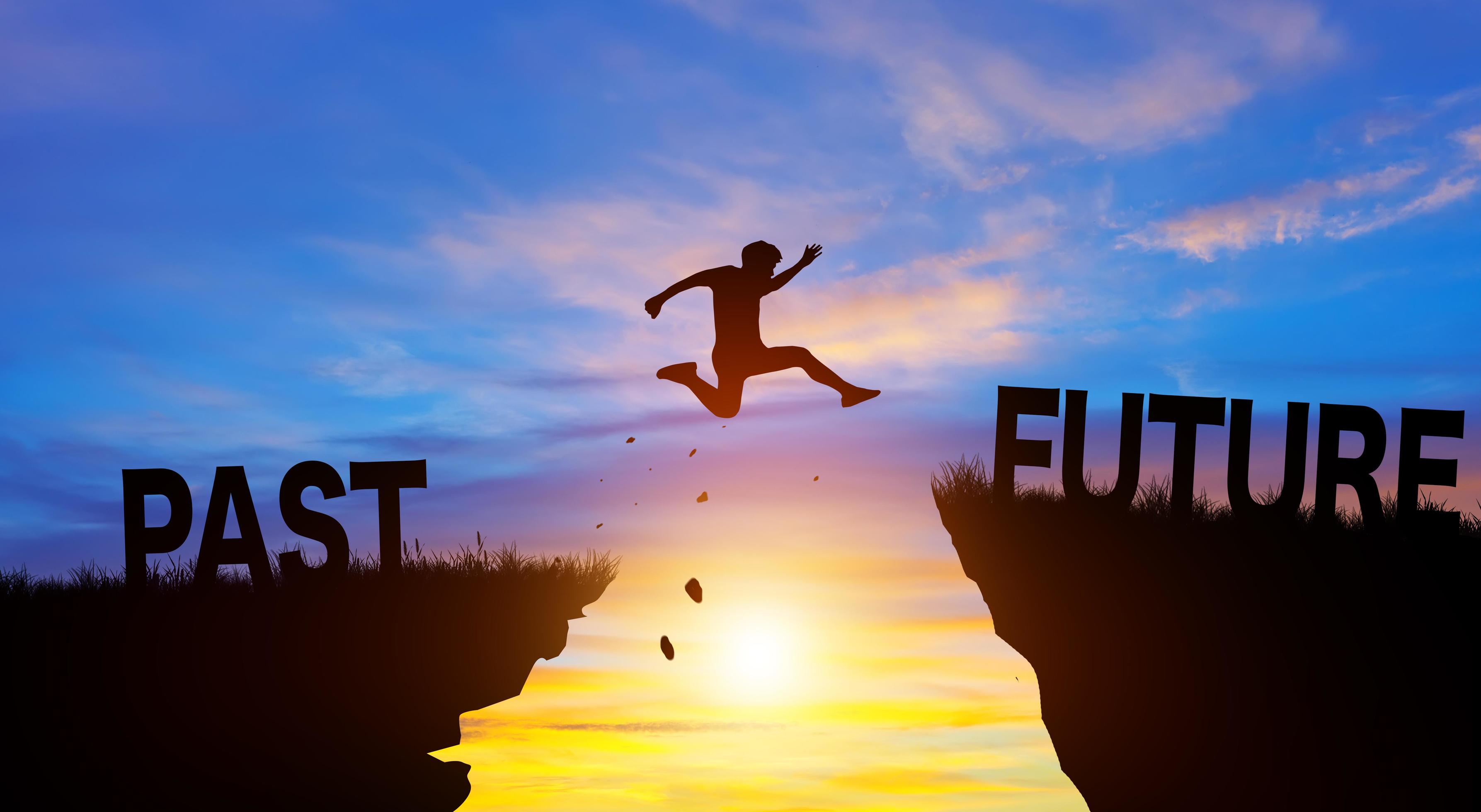 Silhouette man jumping from PAST to FUTURE with sunrise. Go ahead and Keep go on to success