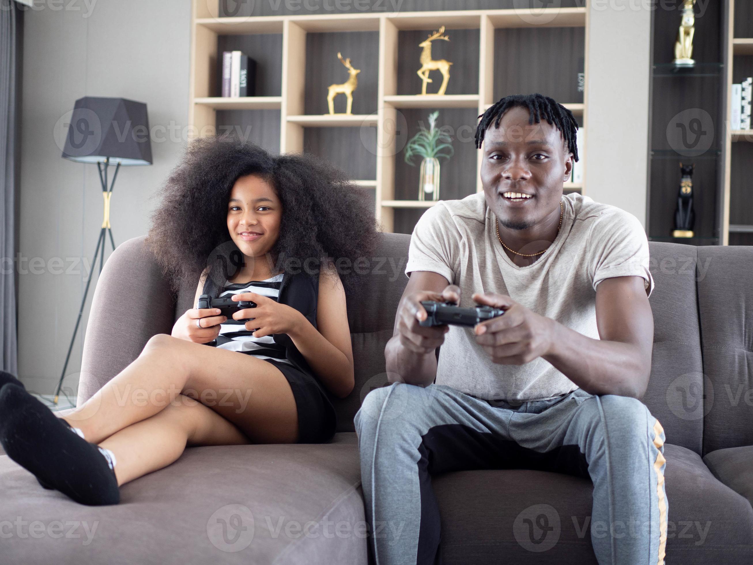 Happy Afro American girlfriend and boyfriend play games on