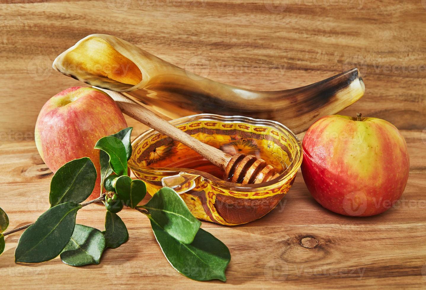 Rosh hashanah - jewish new year holiday concept. An apple-shaped bowl with honey, apples, a shofar are traditional symbols of the holiday. photo