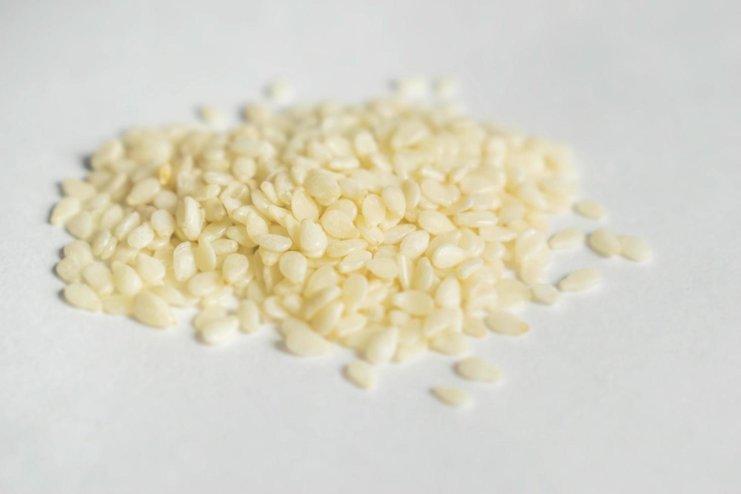 White Sesame seeds are flat, pear-shaped seeds with an off-white color photo