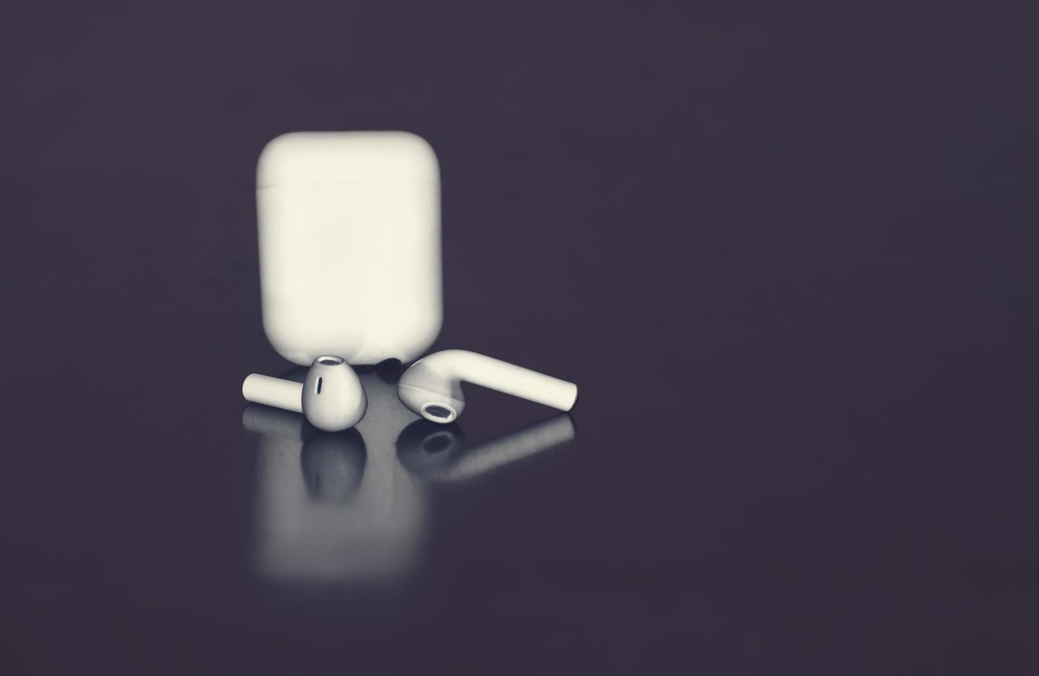 Isolated Air pod in dark background.White color Air Pod. photo