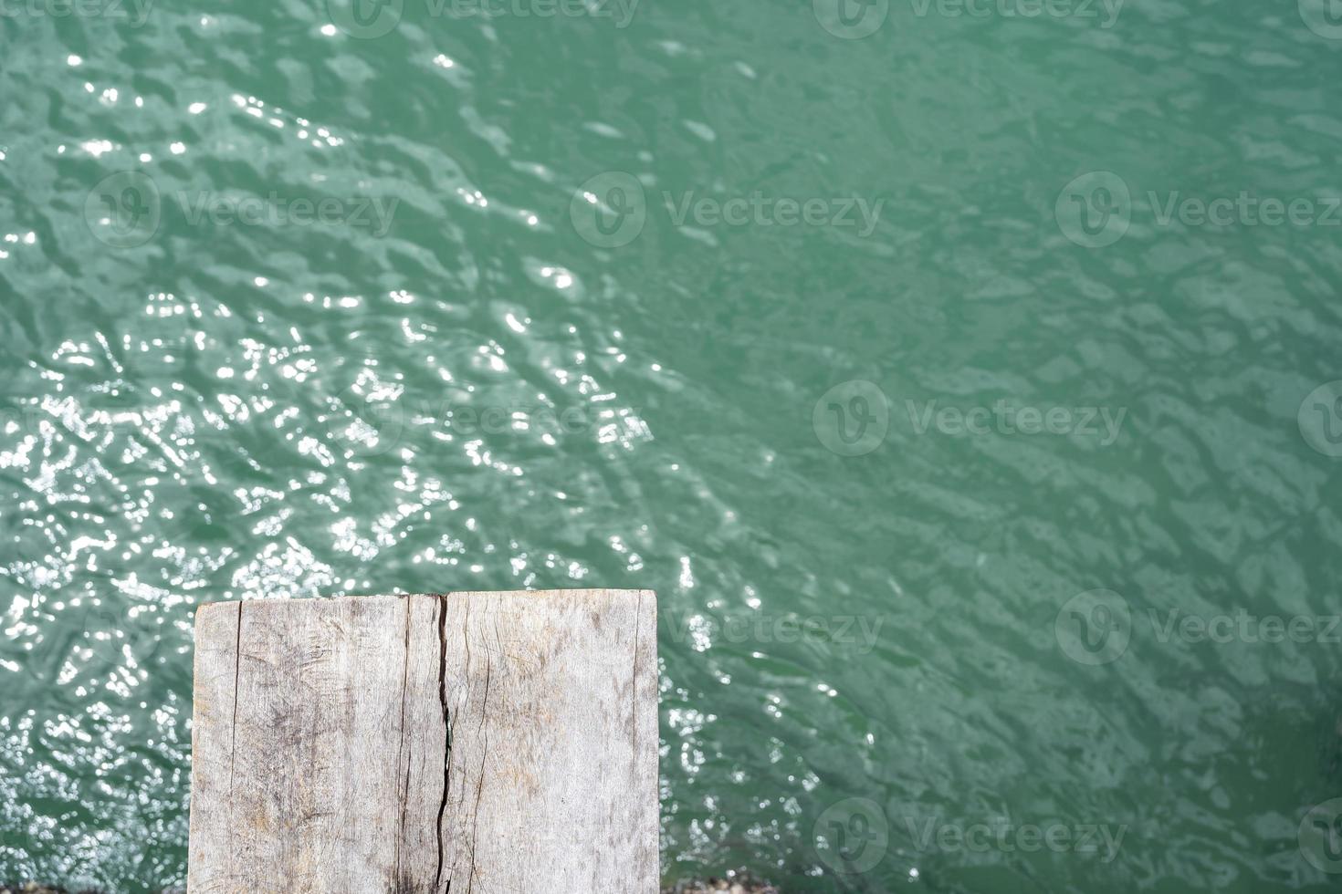 The wood floor extends into the sea. space for product or object presentation photo